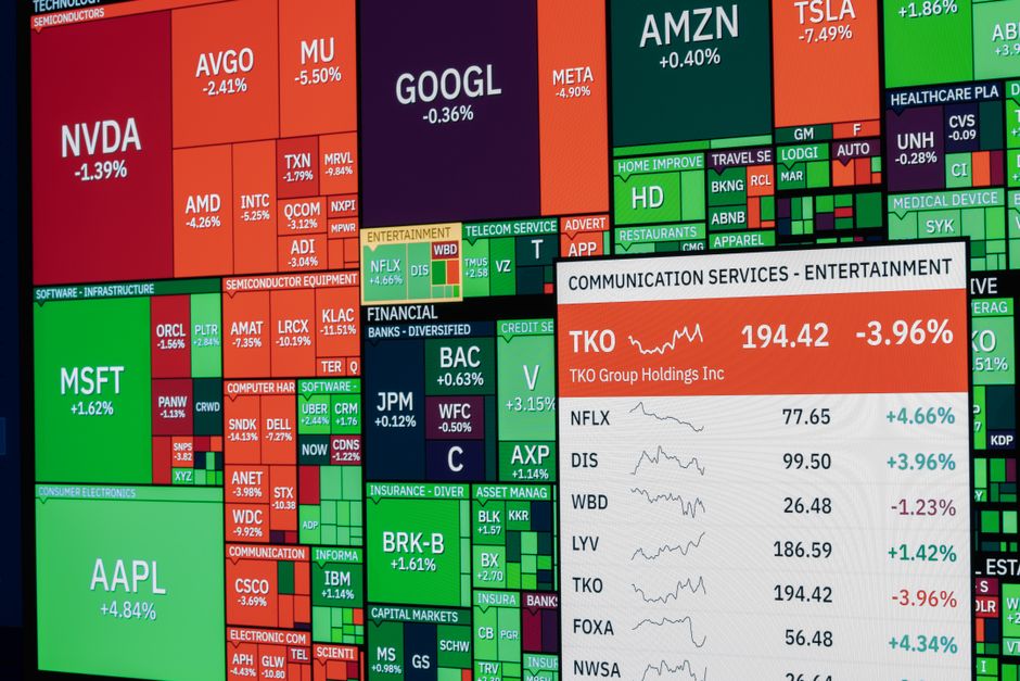 Colorful stock market board displaying various company stock performances and trends.